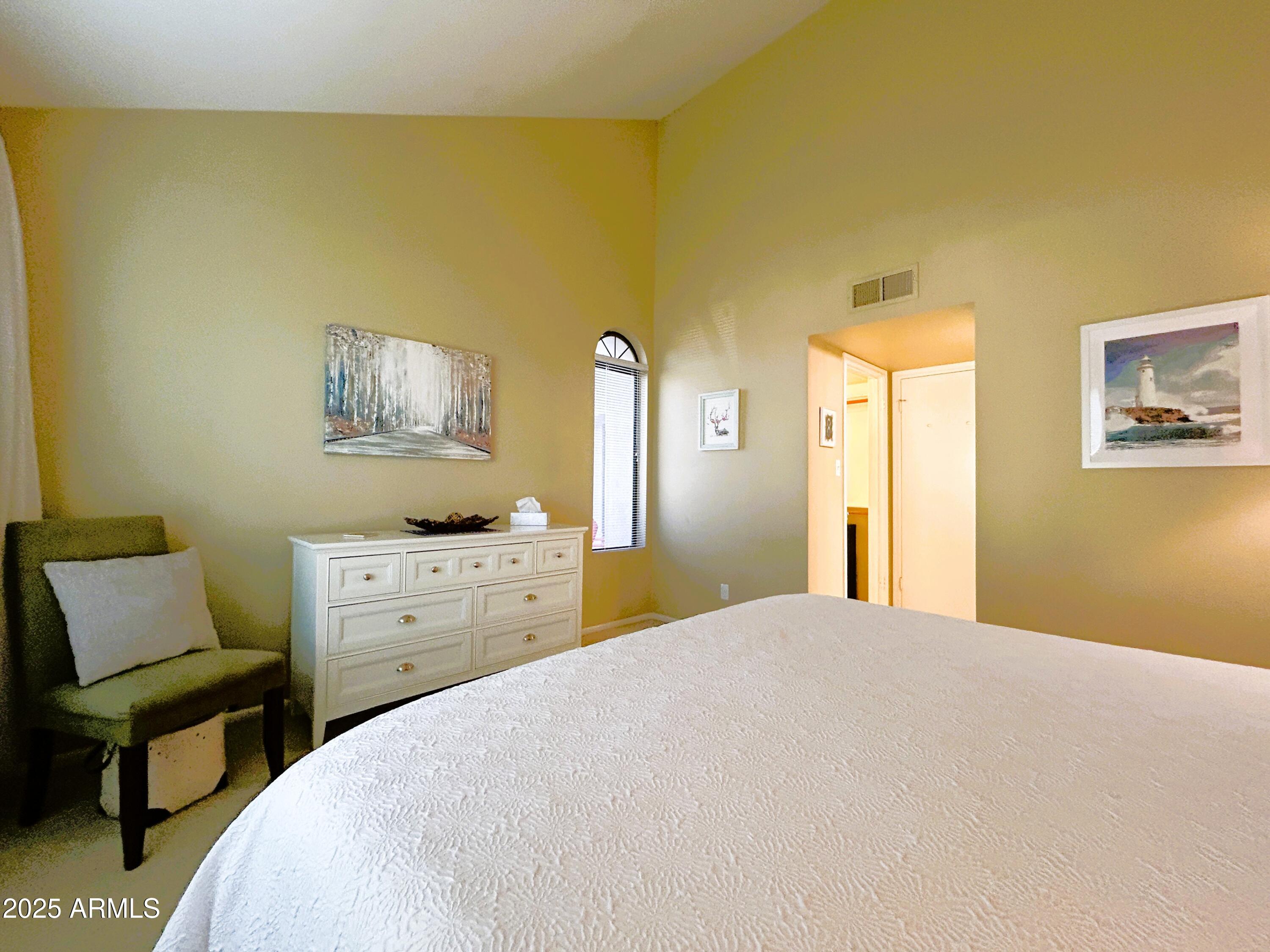 10055 East Mountainview Lake Drive, Unit 2059 Scottsdale, AZ 85258 - Photo 6 of 34 a bedroom with a bed and a chair