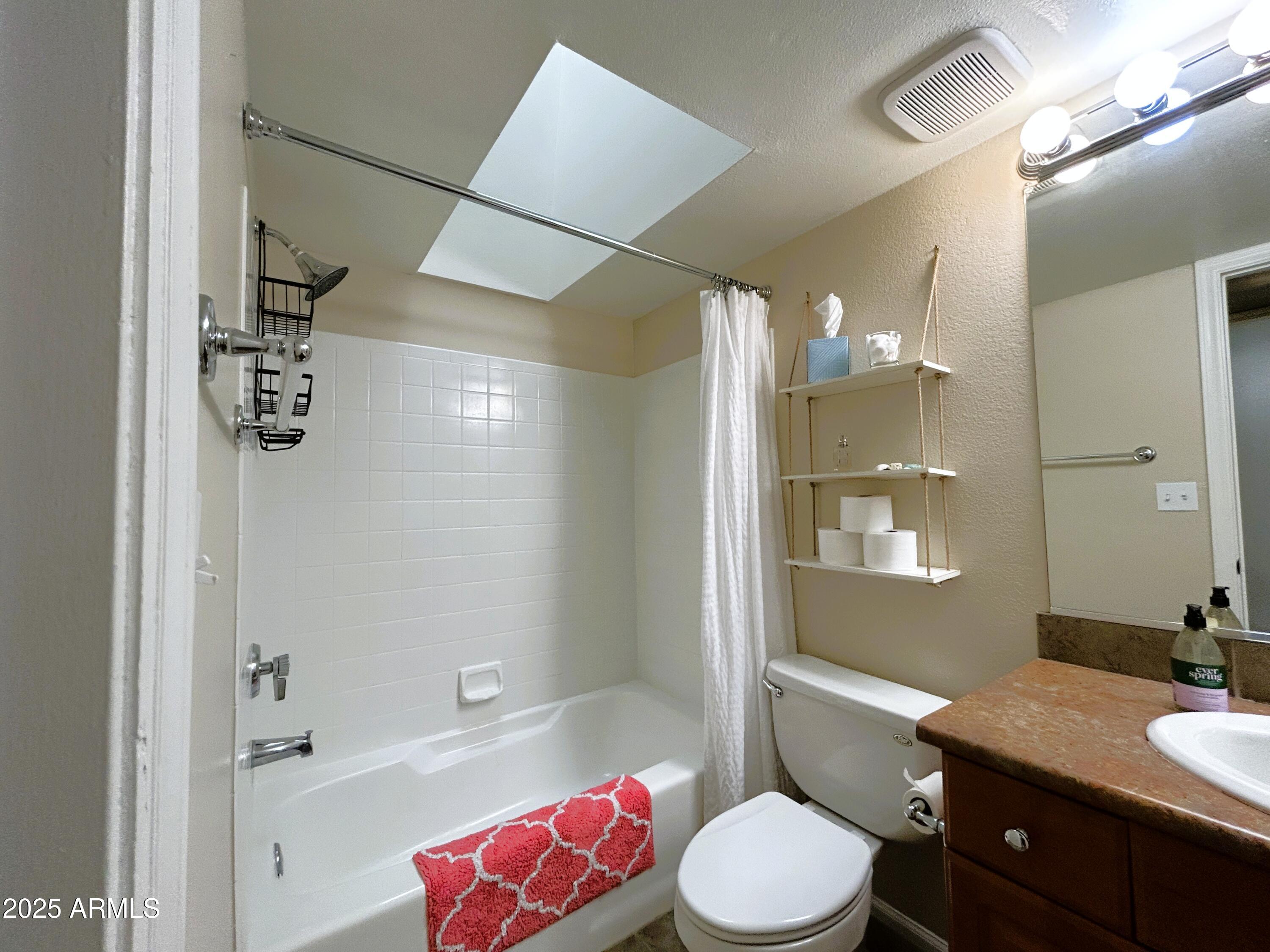 10055 East Mountainview Lake Drive, Unit 2059 Scottsdale, AZ 85258 - Photo 7 of 34 a bathroom with a granite countertop sink toilet a large mirror a shower and bathtub