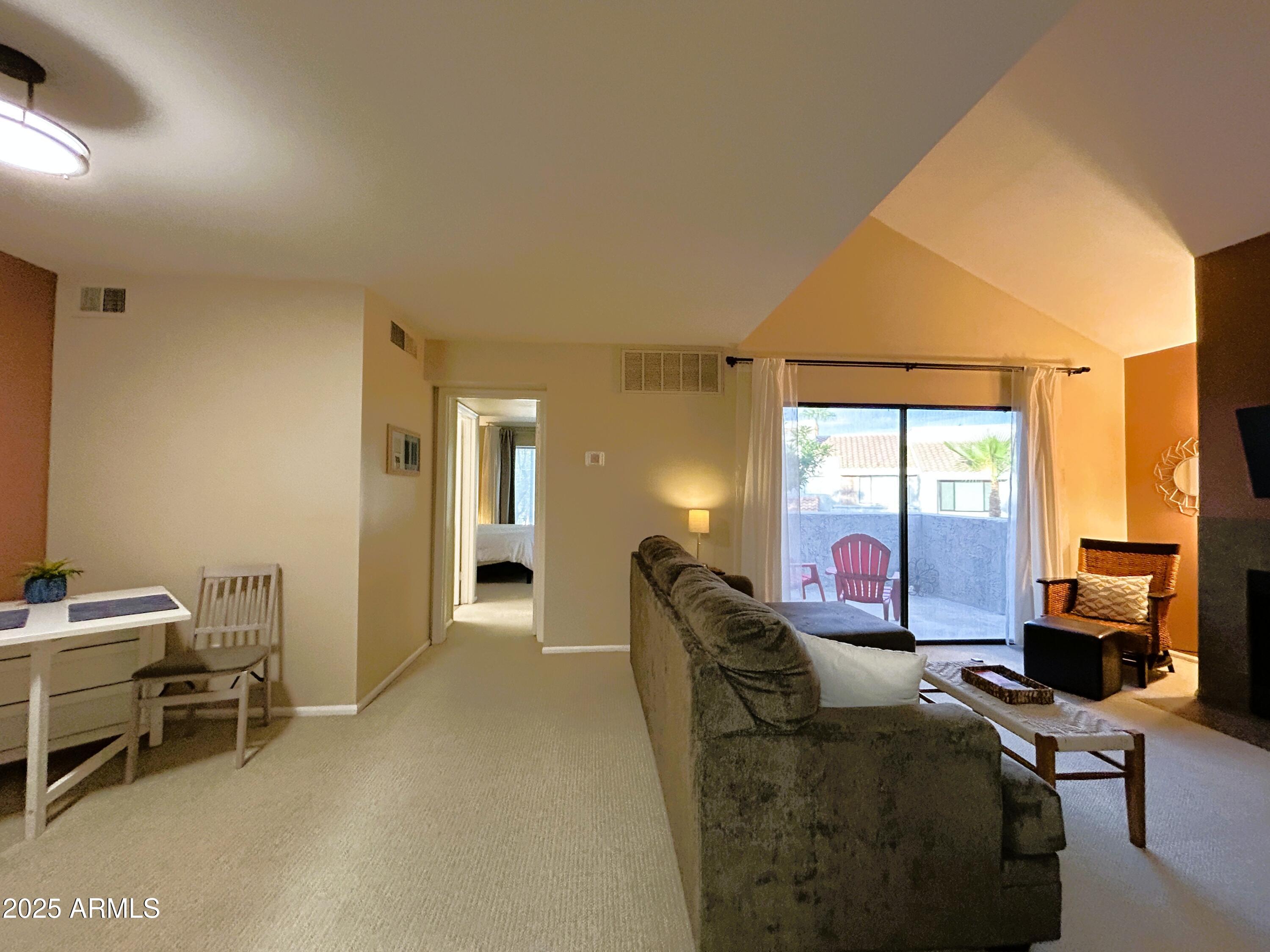 10055 East Mountainview Lake Drive, Unit 2059 Scottsdale, AZ 85258 - Photo 10 of 34 a living room with furniture a flat screen tv and large windows