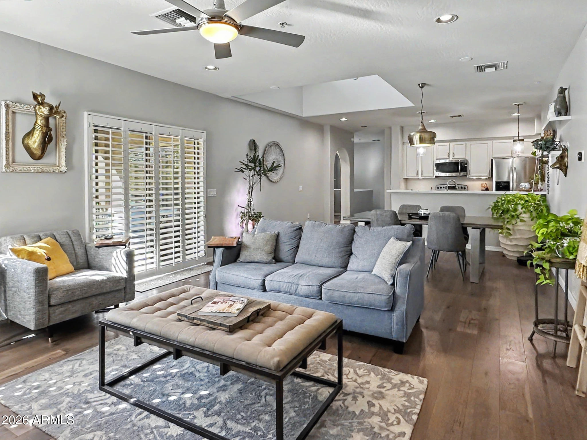 a living room with furniture a chandelier and a table