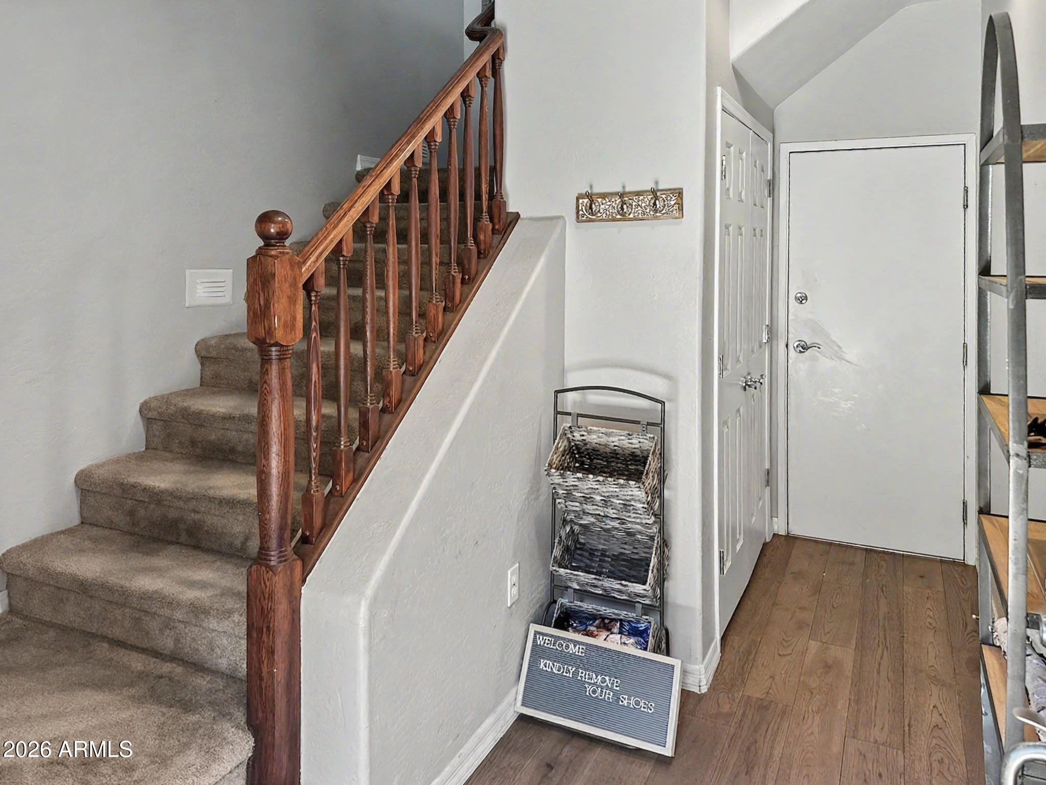 3935 East Rough Rider Road, Unit 1144 Phoenix, AZ 85050 - Photo 18 of 31 a view of a hallway with wooden floor and staircase