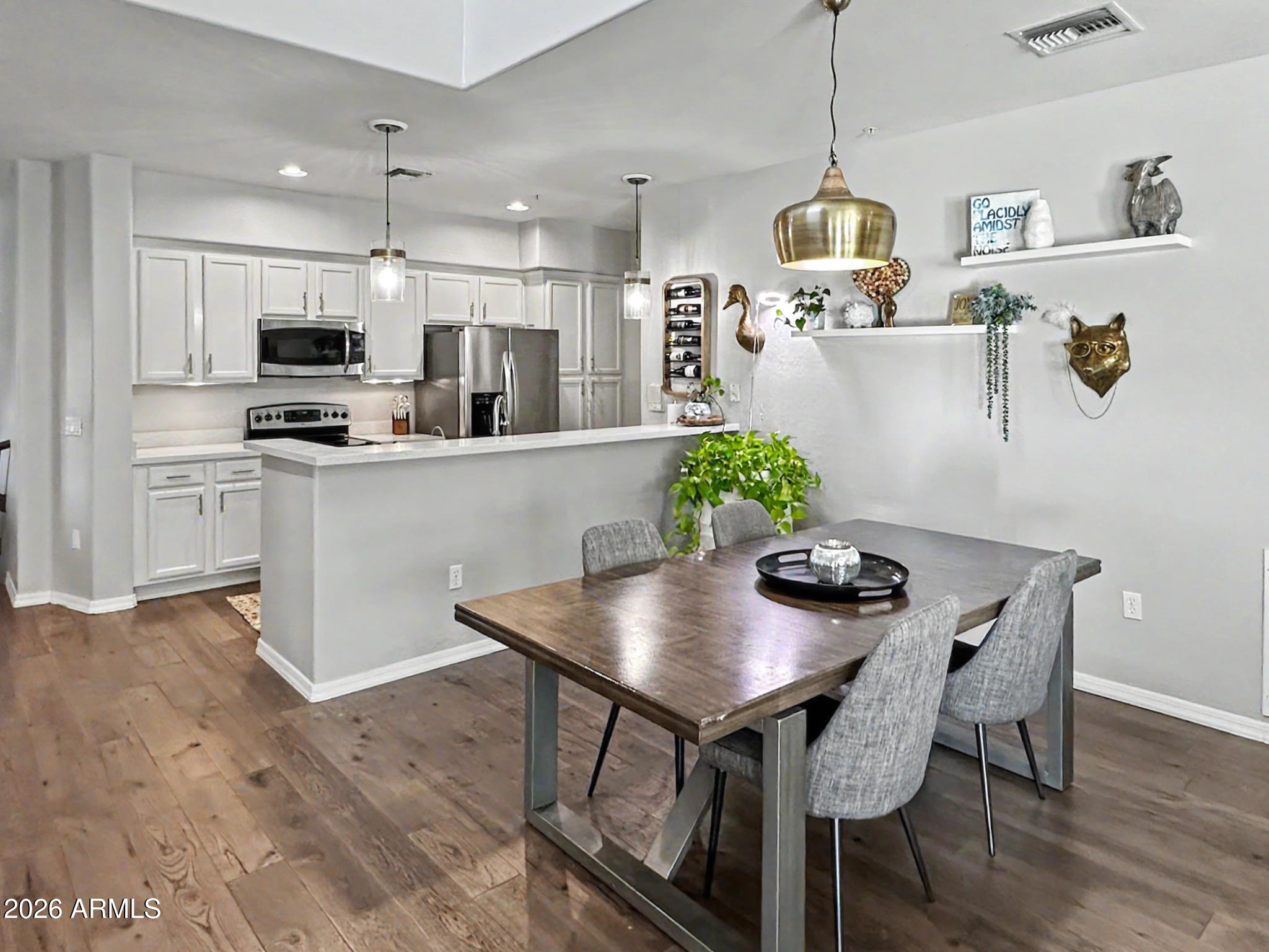 3935 East Rough Rider Road, Unit 1144 Phoenix, AZ 85050 - Photo 2 of 31 a kitchen with a table and chairs in it