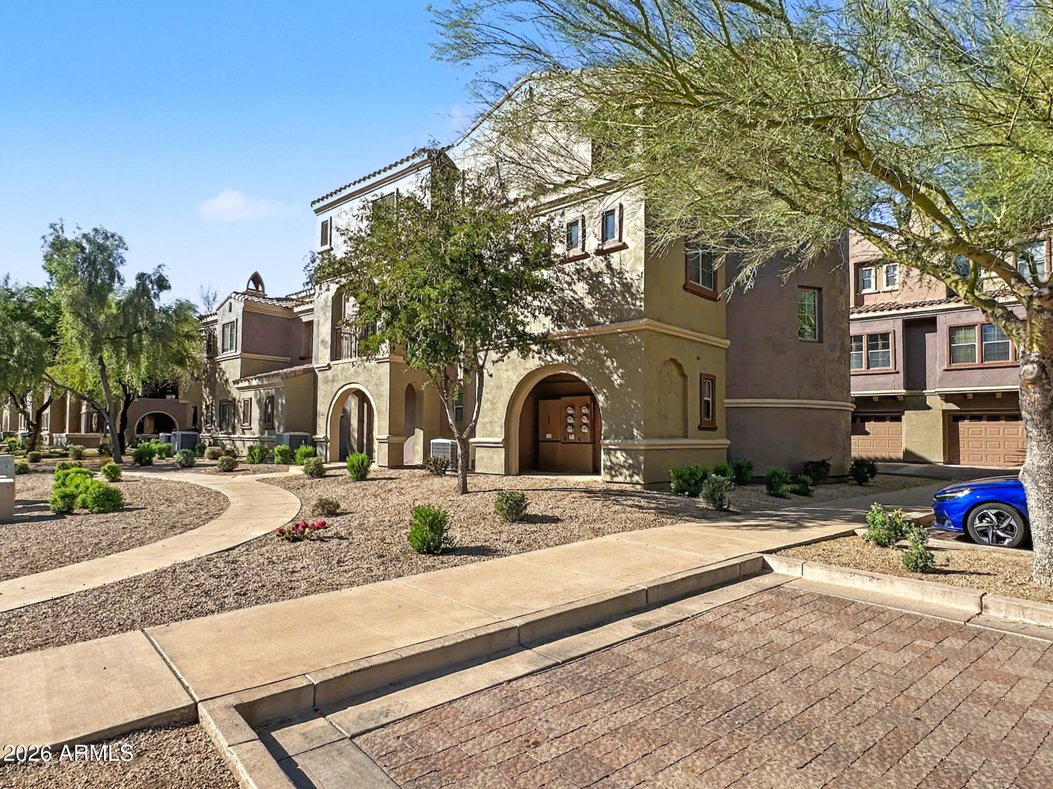 3935 East Rough Rider Road, Unit 1144 Phoenix, AZ 85050 - Photo 21 of 31 a front view of a house with a yard