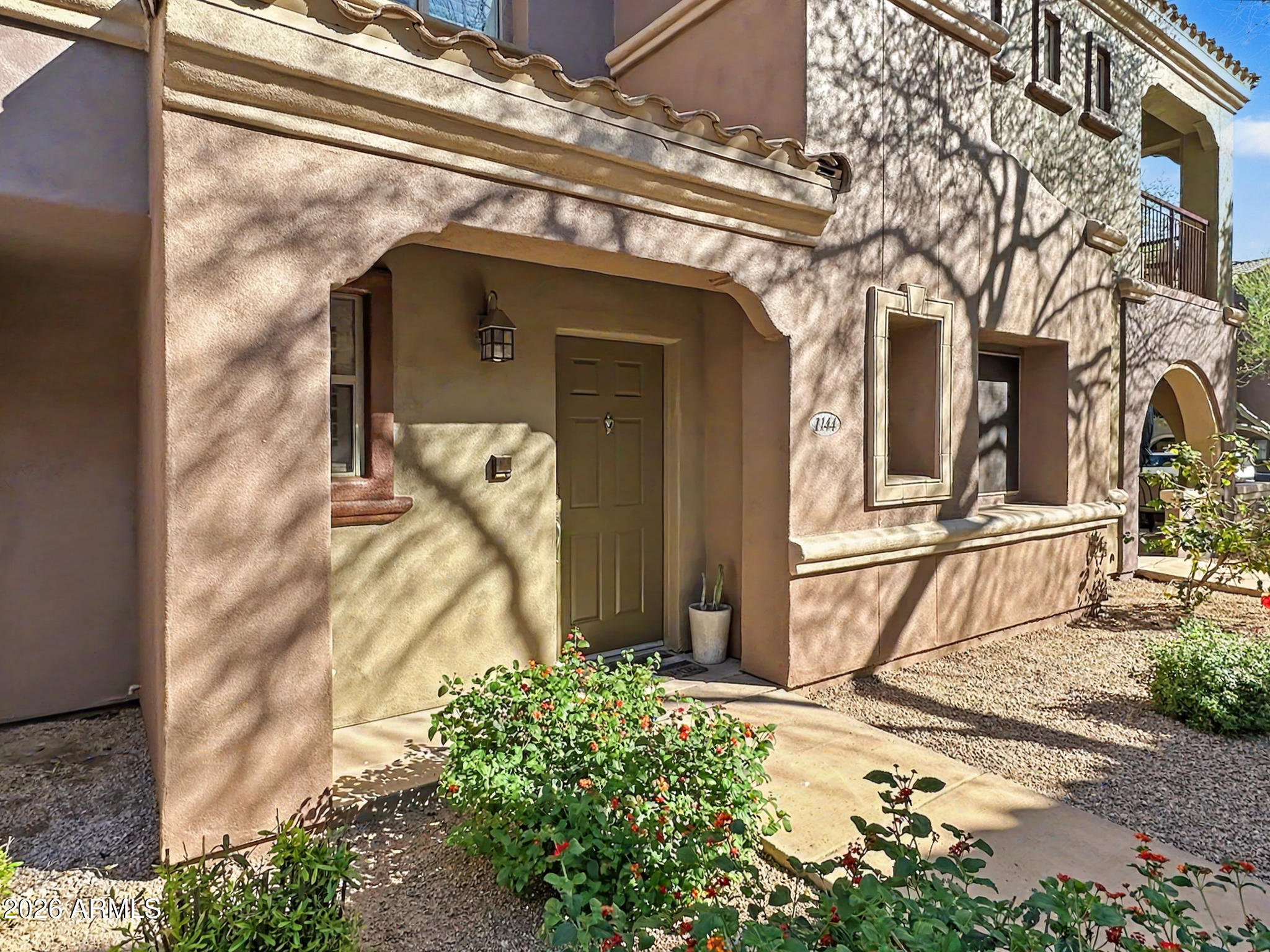 3935 East Rough Rider Road, Unit 1144 Phoenix, AZ 85050 - Photo 22 of 31 a view of a house with a door and porch