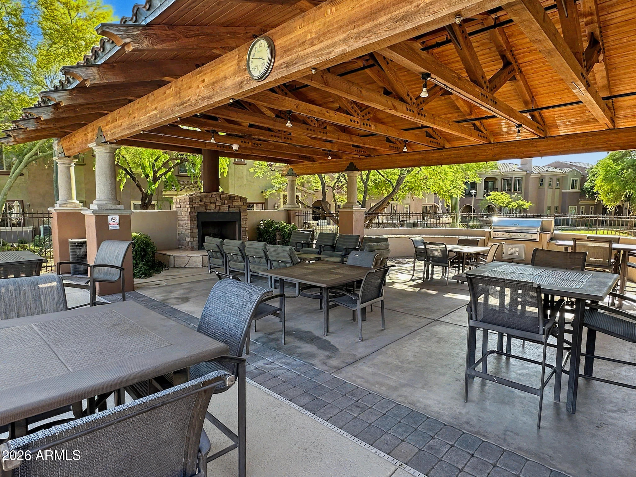 3935 East Rough Rider Road, Unit 1144 Phoenix, AZ 85050 - Photo 24 of 31 a view of a patio with a table and chairs under a large umbrella