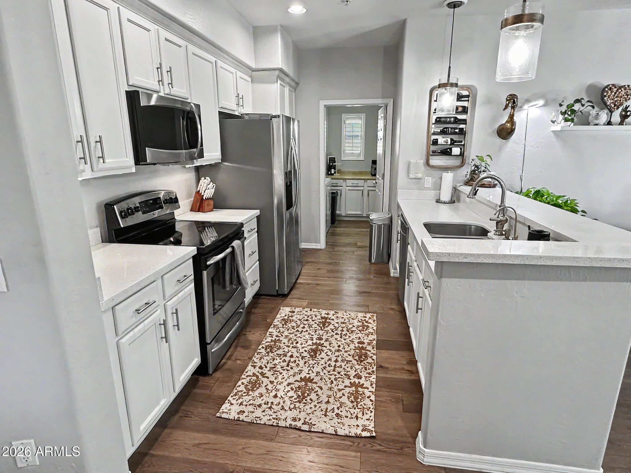 3935 East Rough Rider Road, Unit 1144 Phoenix, AZ 85050 - Photo 3 of 31 a kitchen with a sink stove and refrigerator