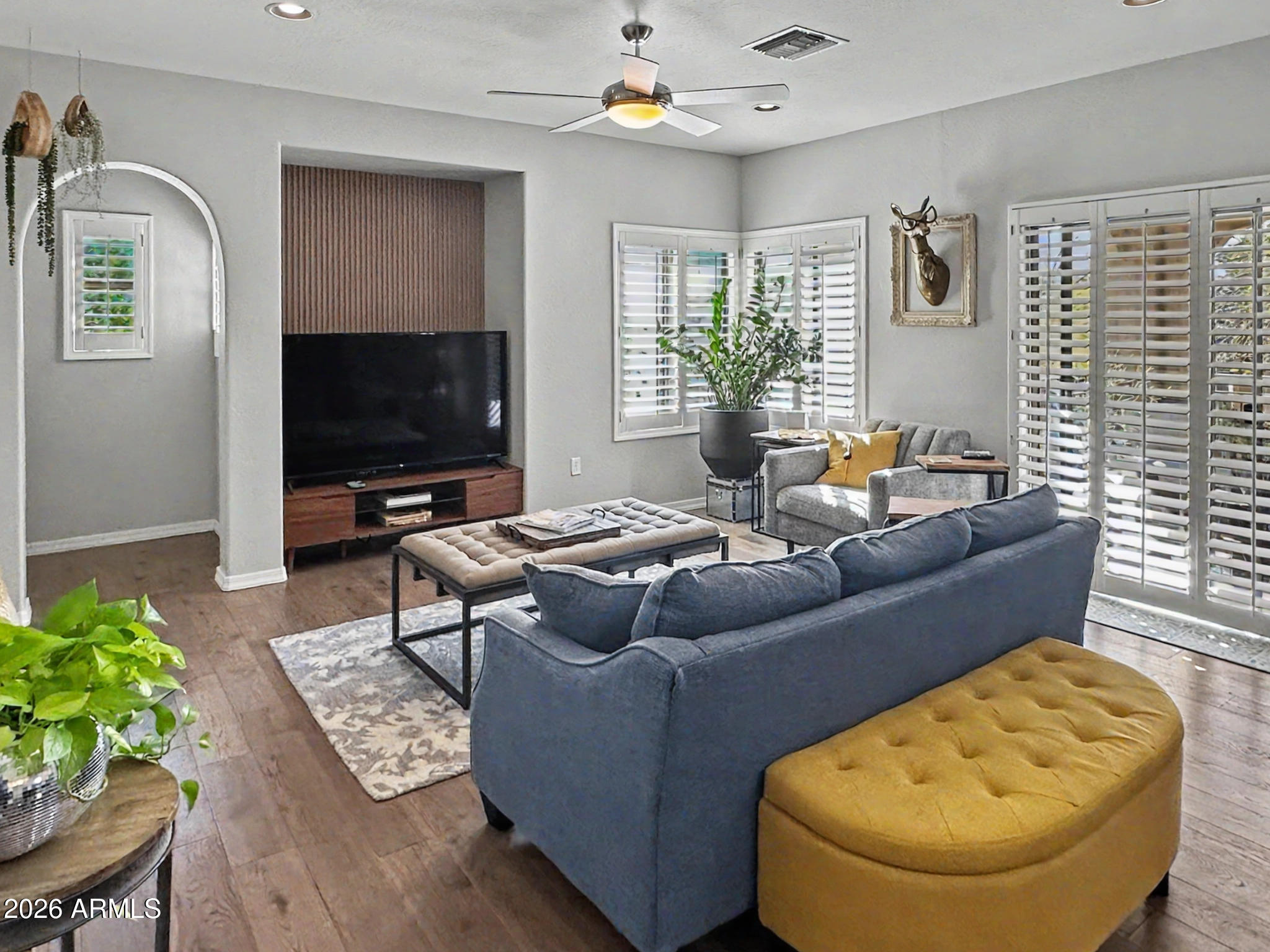 3935 East Rough Rider Road, Unit 1144 Phoenix, AZ 85050 - Photo 4 of 31 a living room with furniture and a flat screen tv