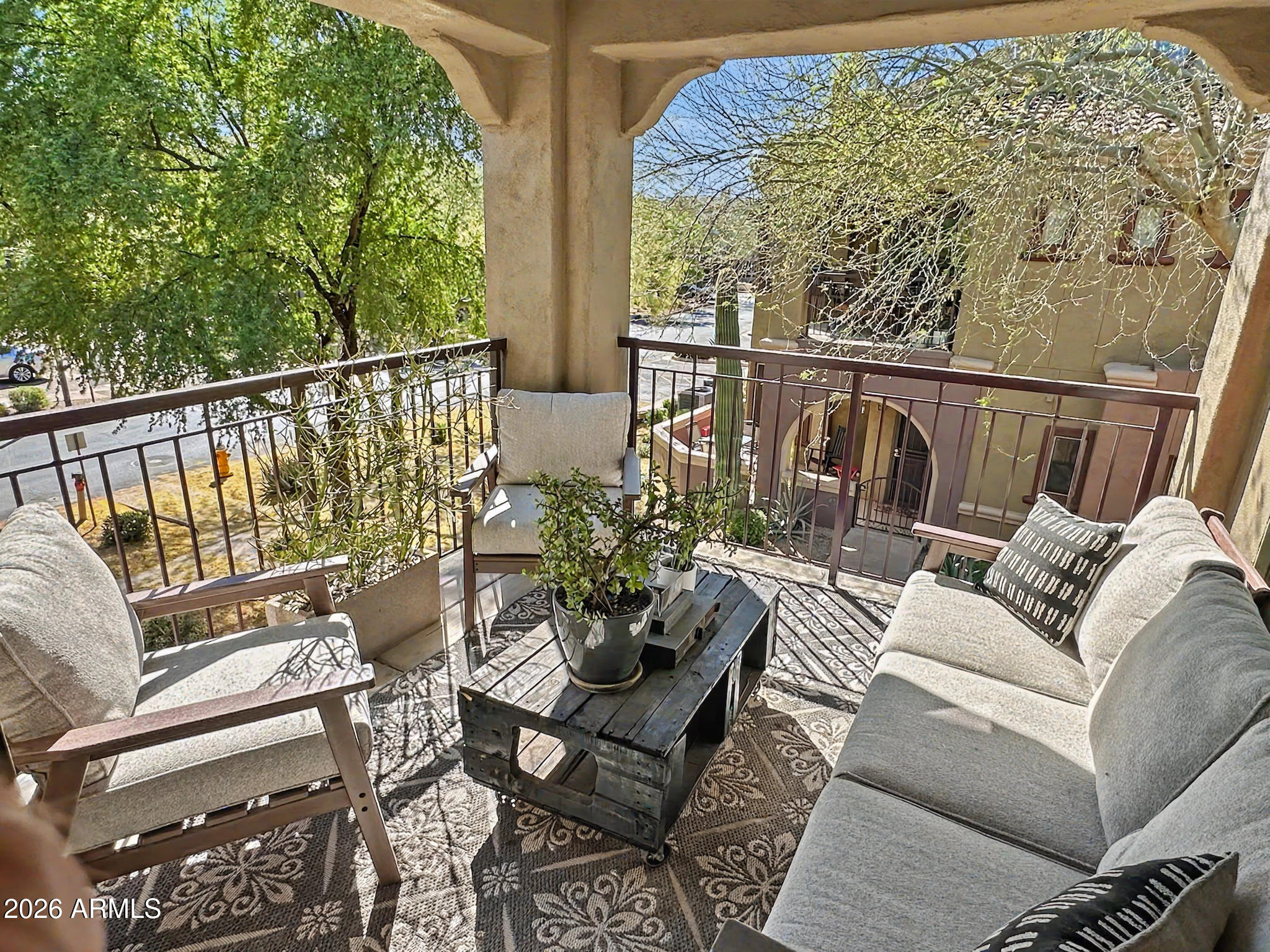 3935 East Rough Rider Road, Unit 1144 Phoenix, AZ 85050 - Photo 5 of 31 a balcony with wooden floor stairs and furniture