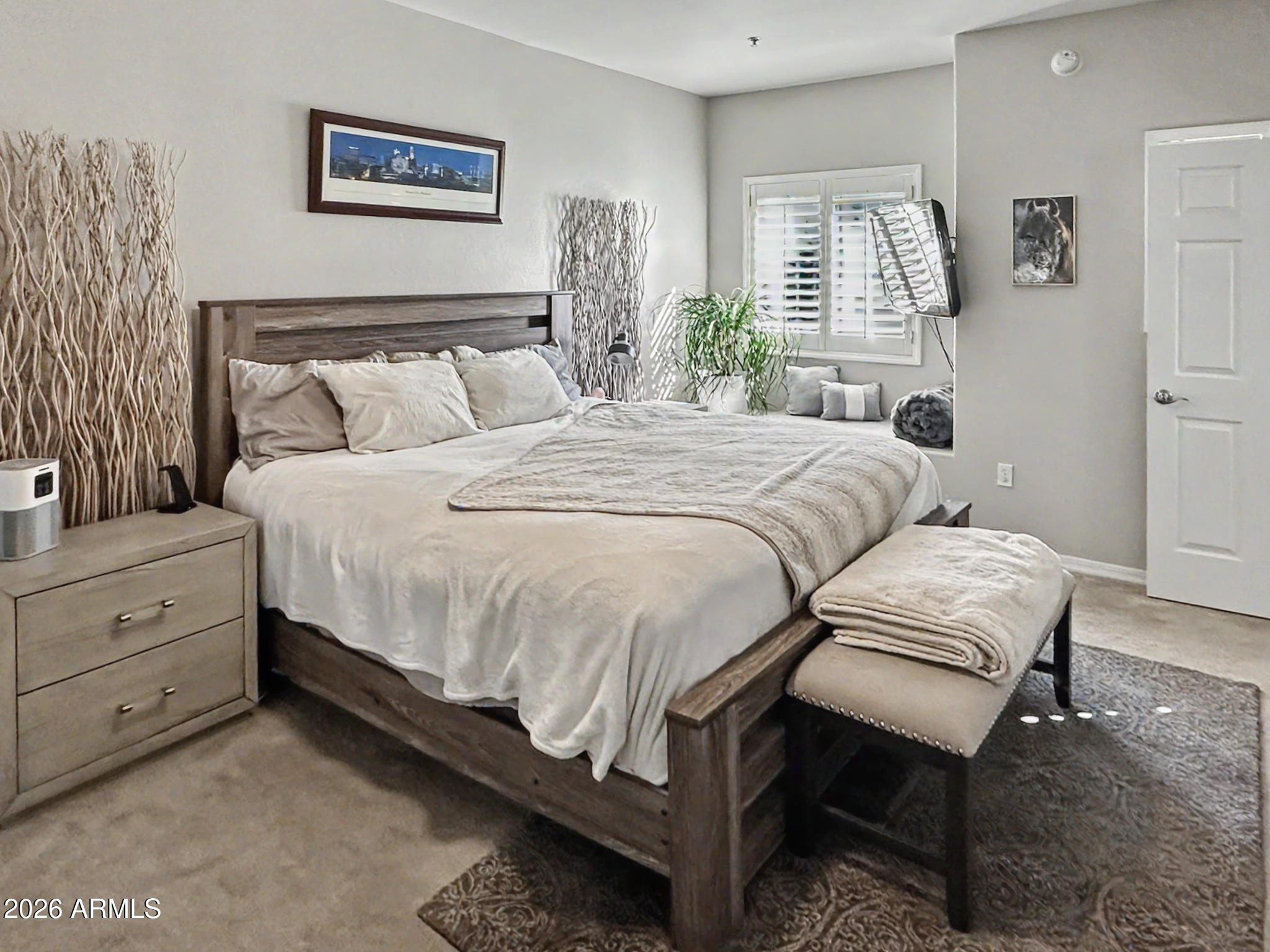 3935 East Rough Rider Road, Unit 1144 Phoenix, AZ 85050 - Photo 8 of 31 a bedroom with a bed and a window