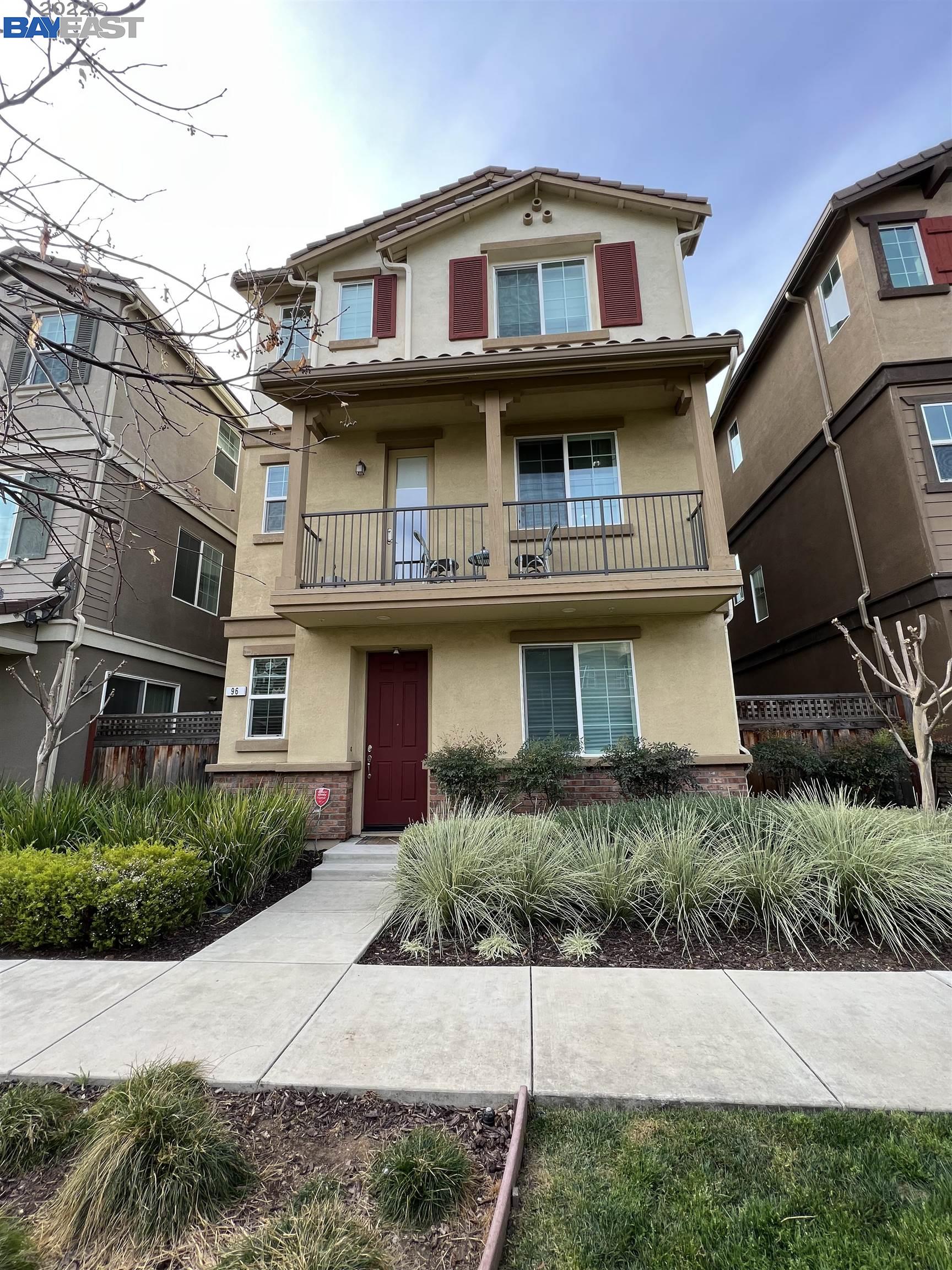 a view of a white building among the street and palm trees
