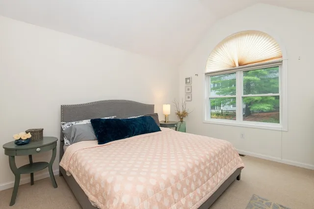 a large bed sitting in a bedroom next to a lamp