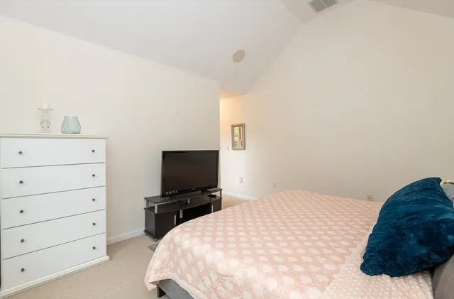 a bedroom with a bed and a lamp