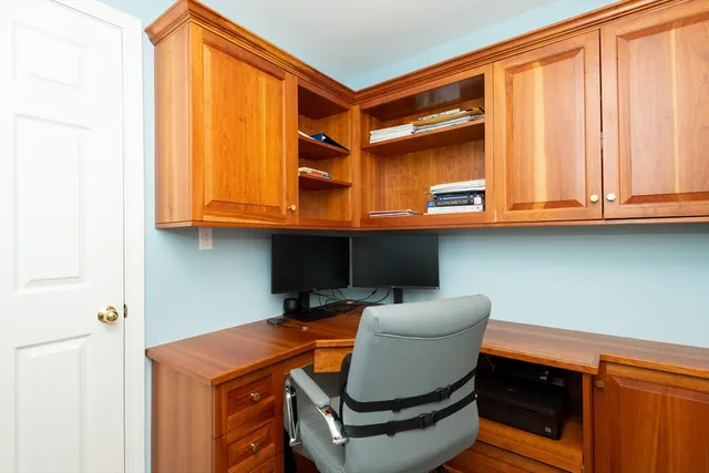 a living room with furniture a fireplace and a large window