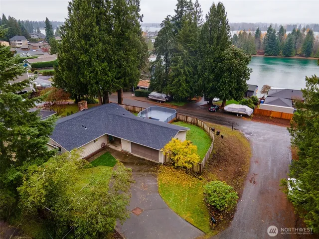an aerial view of a house with swimming pool and a yard