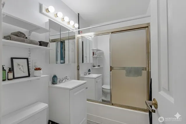 a bathroom with a sink toilet and shower