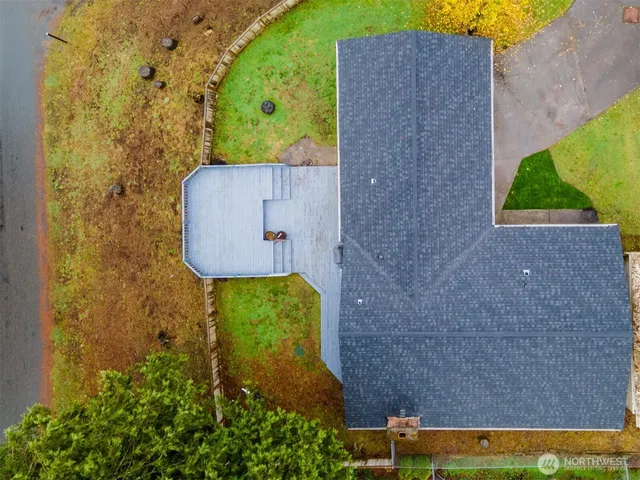 front view of a brick house with a yard and plants