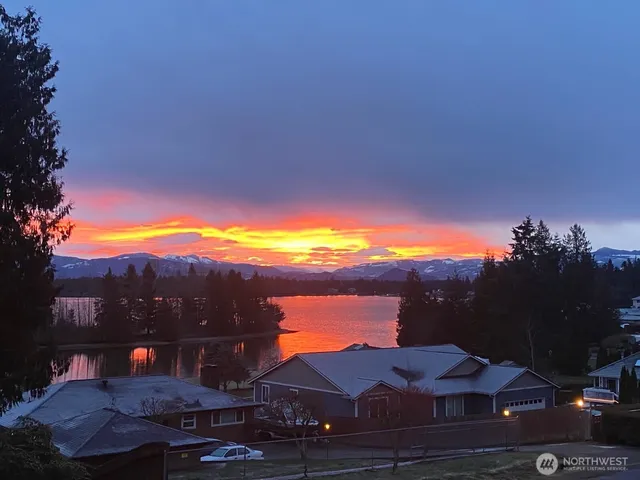 a view of a house with a yard and a sitting area
