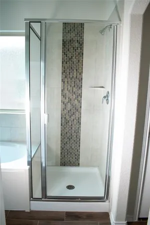 a bathroom with a glass shower door