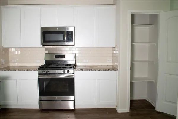 a kitchen with a stove and a microwave