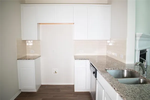 a kitchen with granite countertop a sink and a stove
