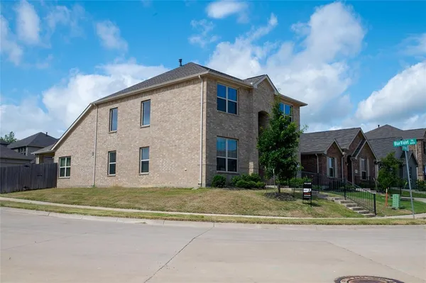 a view of street along with house and trees