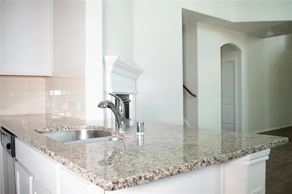 a view of a kitchen counter top a sink and a window