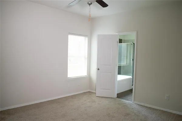 an empty room with a bathroom and a sink