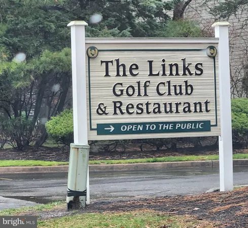 a view of a sign board with a yard