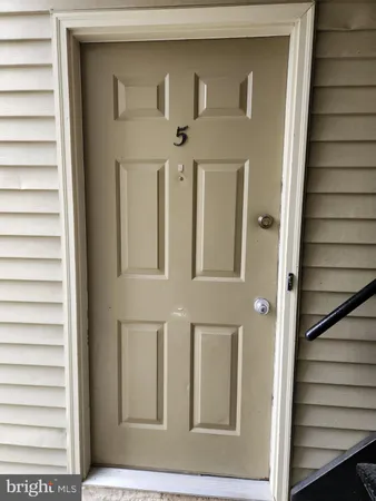 a view of a brick house with a door and a window