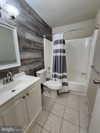 a bathroom with a sink a toilet and tub