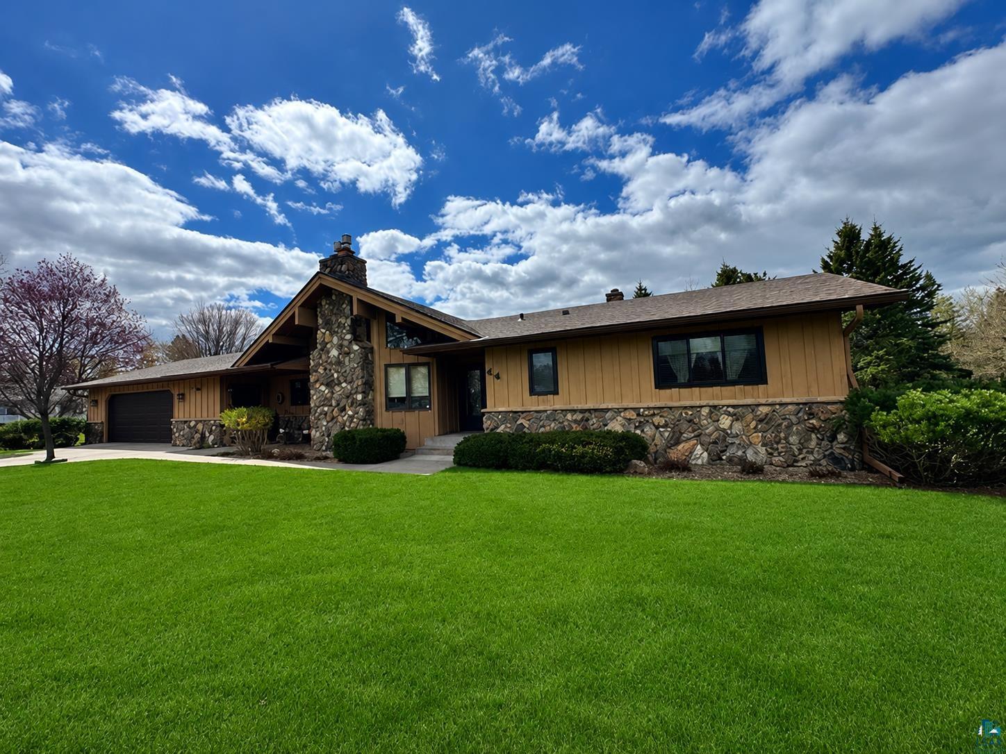 44 Highgate Street Superior, WI 54880 - Photo 1 of 1 Exterior featuring stone veneer and vertical wood siding