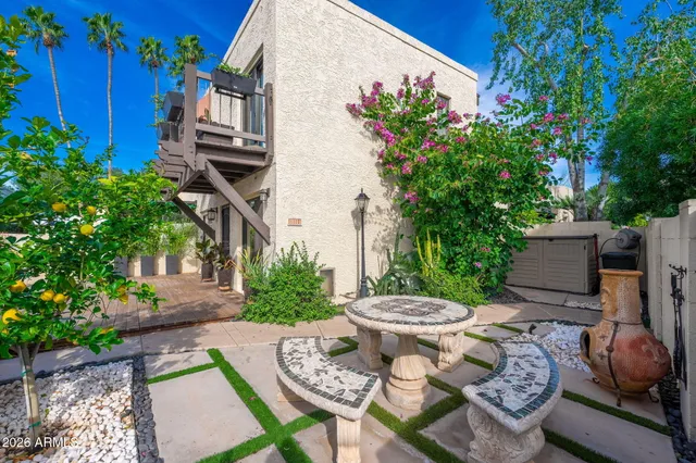 a kitchen with stainless steel appliances a sink a counter top space cabinets and a potted plant