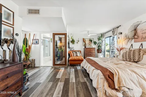 a bedroom with a bed and a mirror