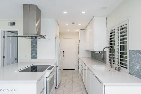 a kitchen with a sink and a refrigerator