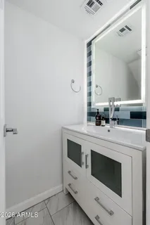 a bathroom with a sink and a mirror