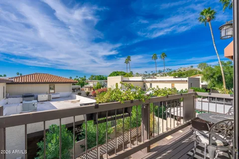a view of a balcony with outdoor seating