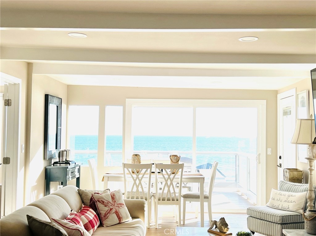 a living room with furniture and floor to ceiling windows