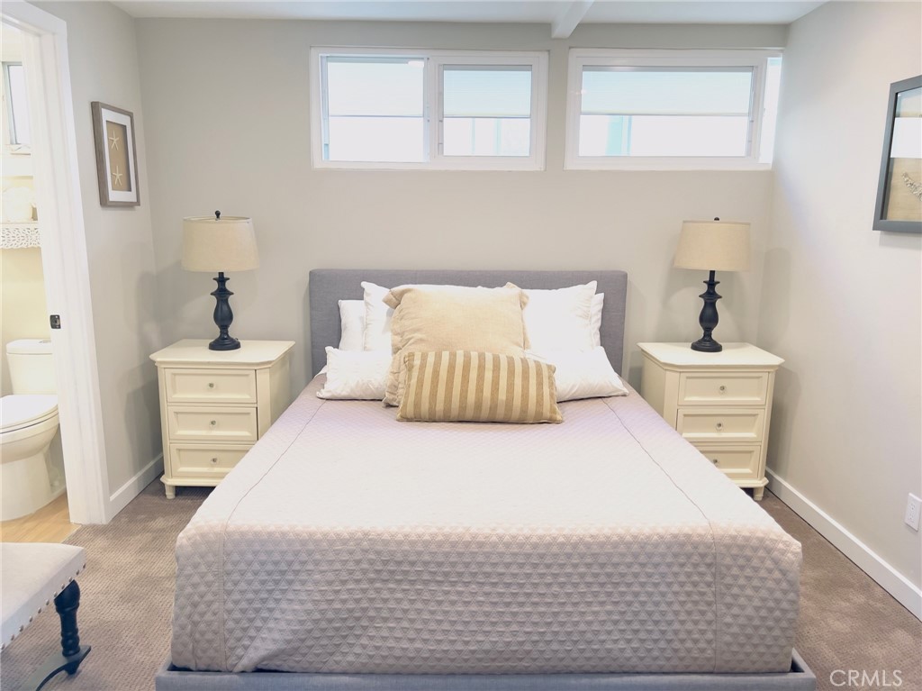 35091 Beach Road Dana Point, CA 92624 - Photo 16 of 27 a bedroom with a bed and wooden floor