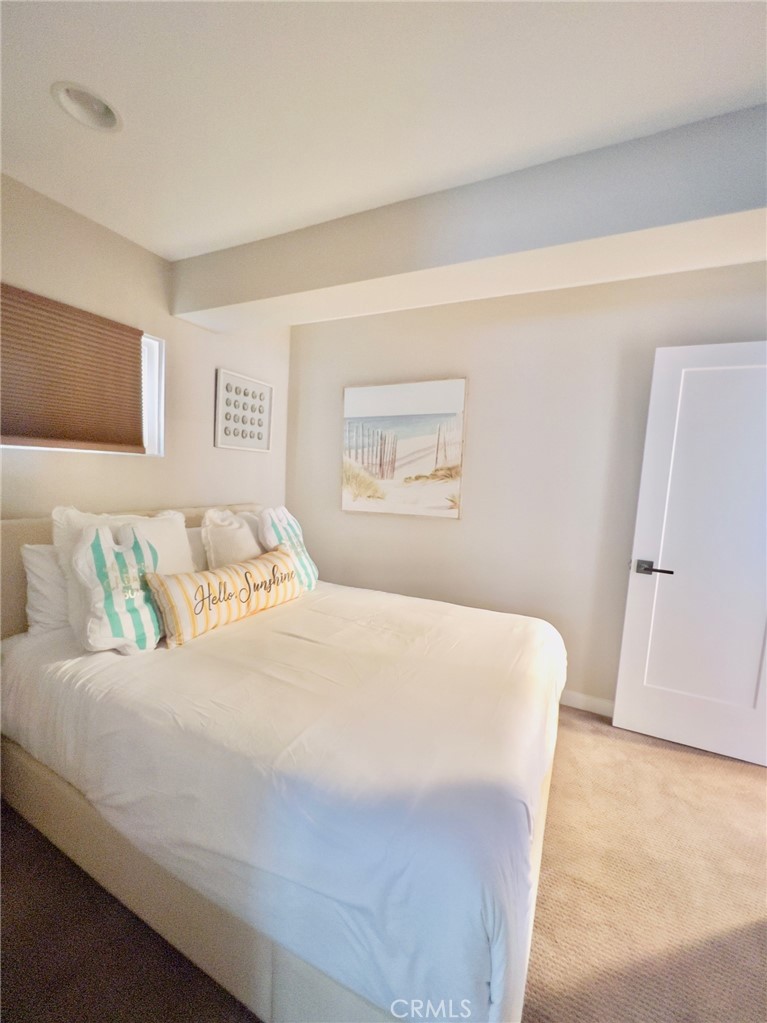 35091 Beach Road Dana Point, CA 92624 - Photo 17 of 27 a bedroom with a bed and a painting on the wall