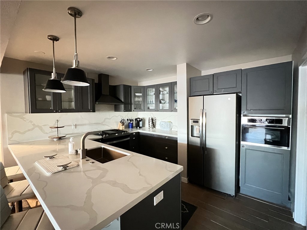 35091 Beach Road Dana Point, CA 92624 - Photo 8 of 27 a kitchen with a sink a kitchen island a stove and a refrigerator