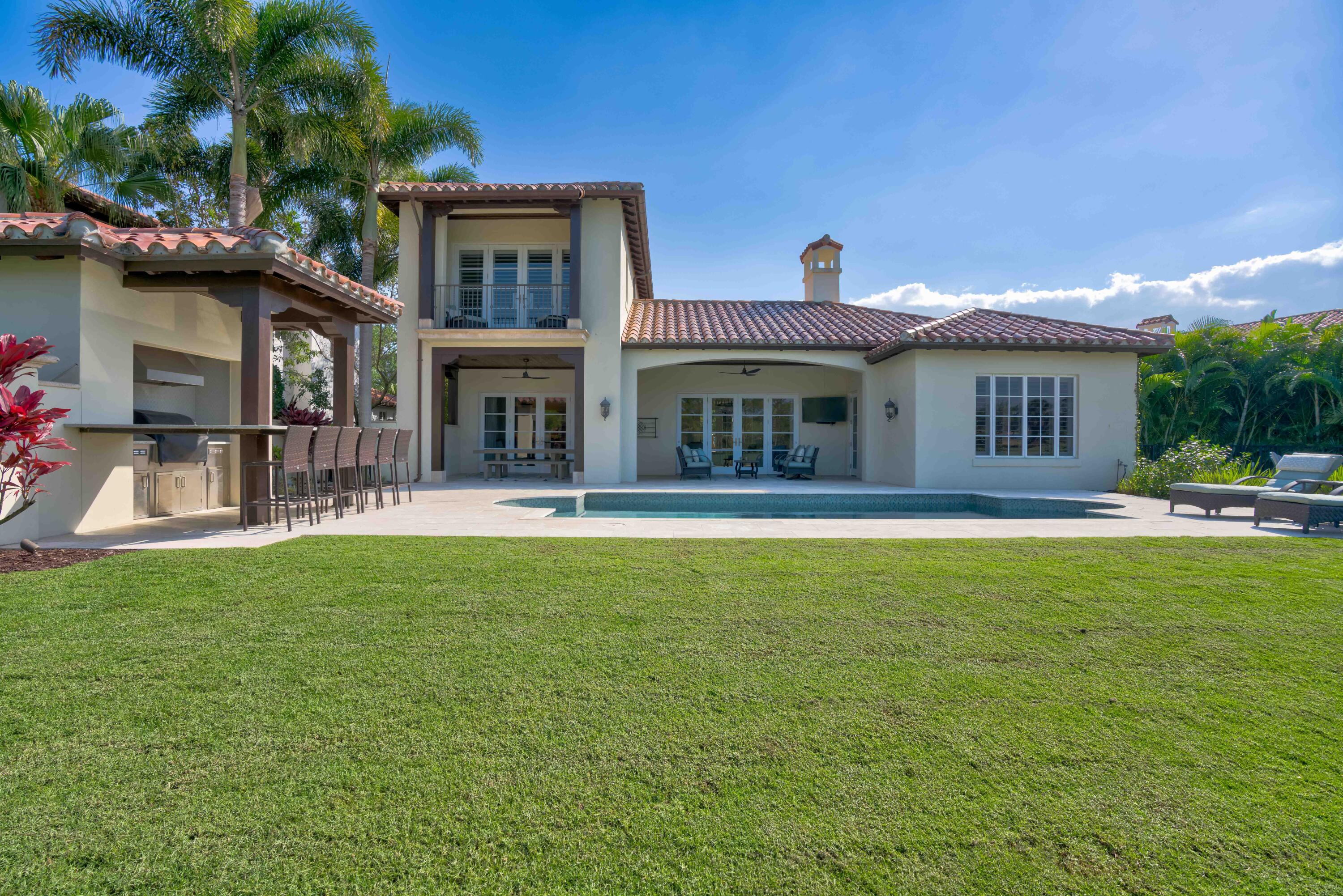 444 Red Hawk Drive Jupiter, FL 33477 - Photo 37 of 58 a front view of house with yard and outdoor seating