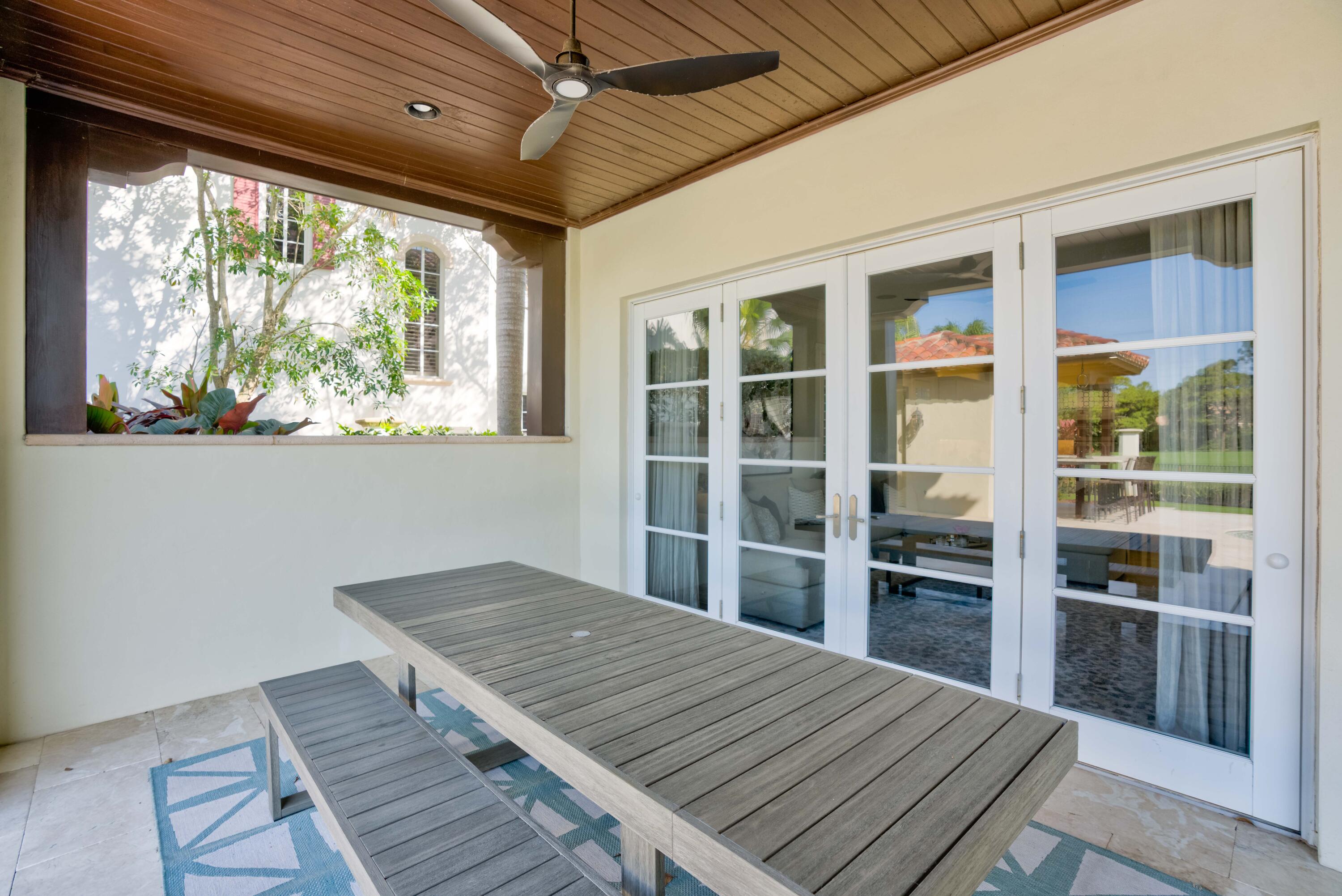 444 Red Hawk Drive Jupiter, FL 33477 - Photo 45 of 58 a view of a bedroom with wooden floor and windows