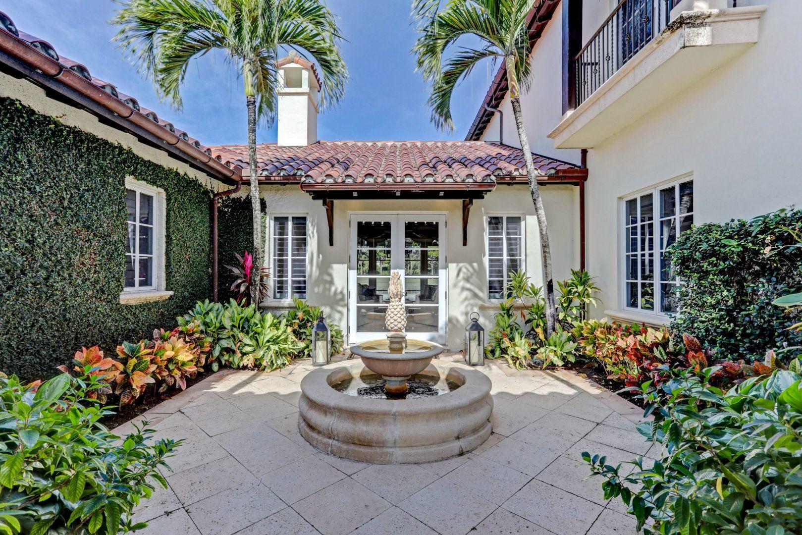 444 Red Hawk Drive Jupiter, FL 33477 - Photo 6 of 58 front view of a house with potted plants