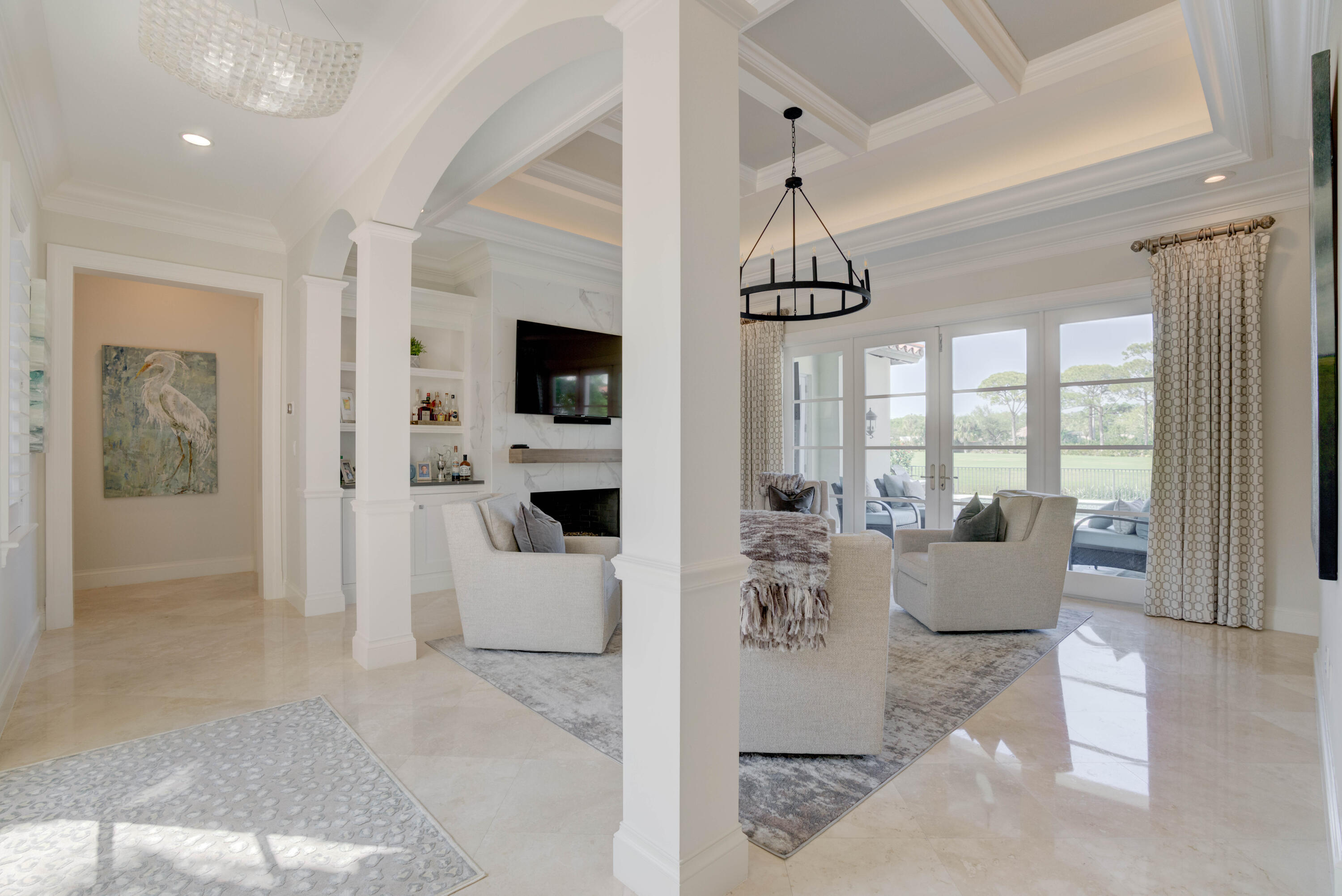 444 Red Hawk Drive Jupiter, FL 33477 - Photo 8 of 58 a living room with furniture a flat screen tv and a chandelier