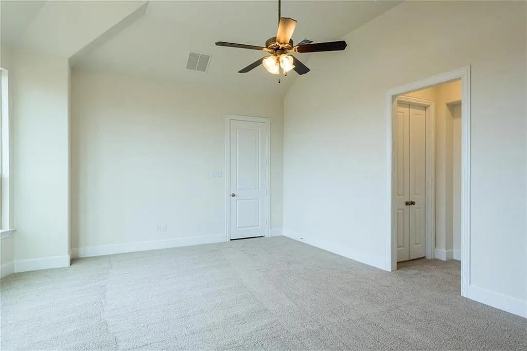 16138 Moonseed Road Frisco, TX 75033 - Photo 18 of 24 Unfurnished bedroom with light colored carpet, vaulted ceiling, and ceiling fan