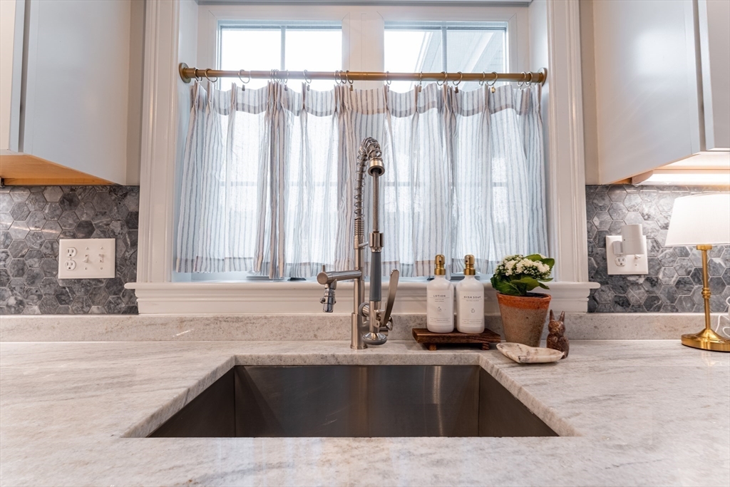 38 Cherry Street, Unit B Hudson, MA 01749 - Photo 6 of 33 a view of a kitchen with a sink and a potted plant