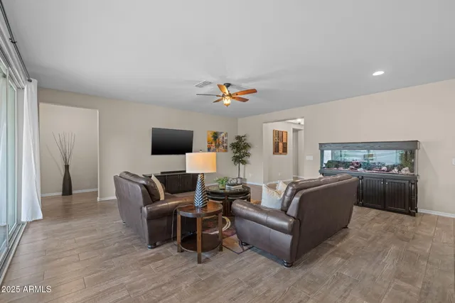 a kitchen with kitchen island granite countertop wooden cabinets and a refrigerator