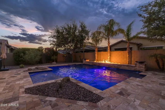 a view of a swimming pool with some potted plants