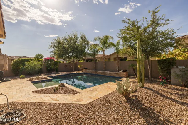 a living room with patio furniture and a floor to ceiling window