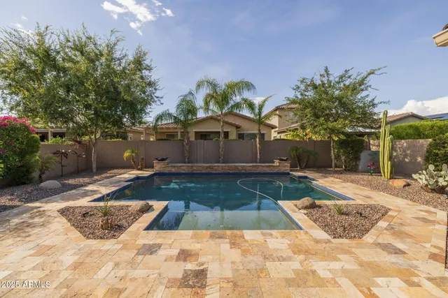 a view of a swimming pool with an outdoor seating